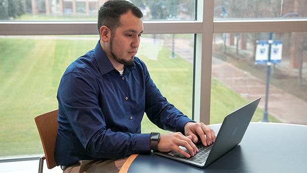 Male Student on his Laptop